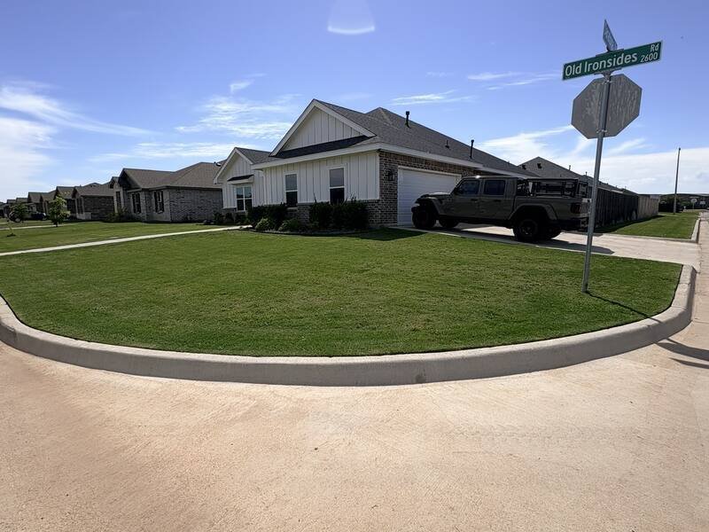 Corner lot lawn, freshly mowed and edged, Abilene, TX