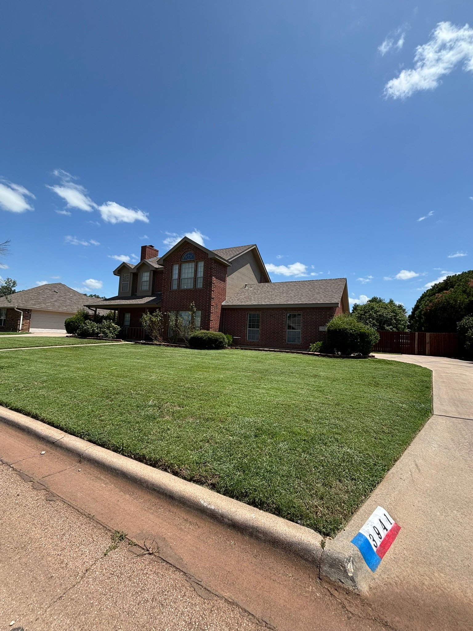Two-story brick home lawn service – Abilene TX